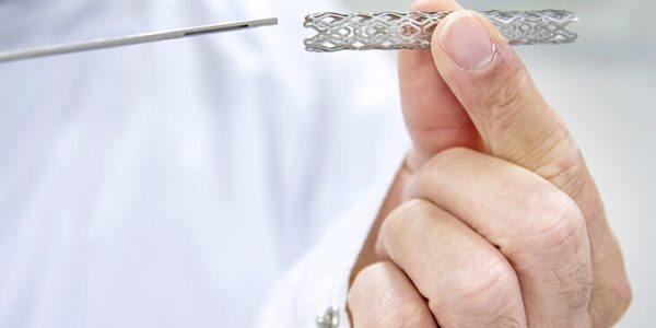 Man Holding Heart Stent In Hand